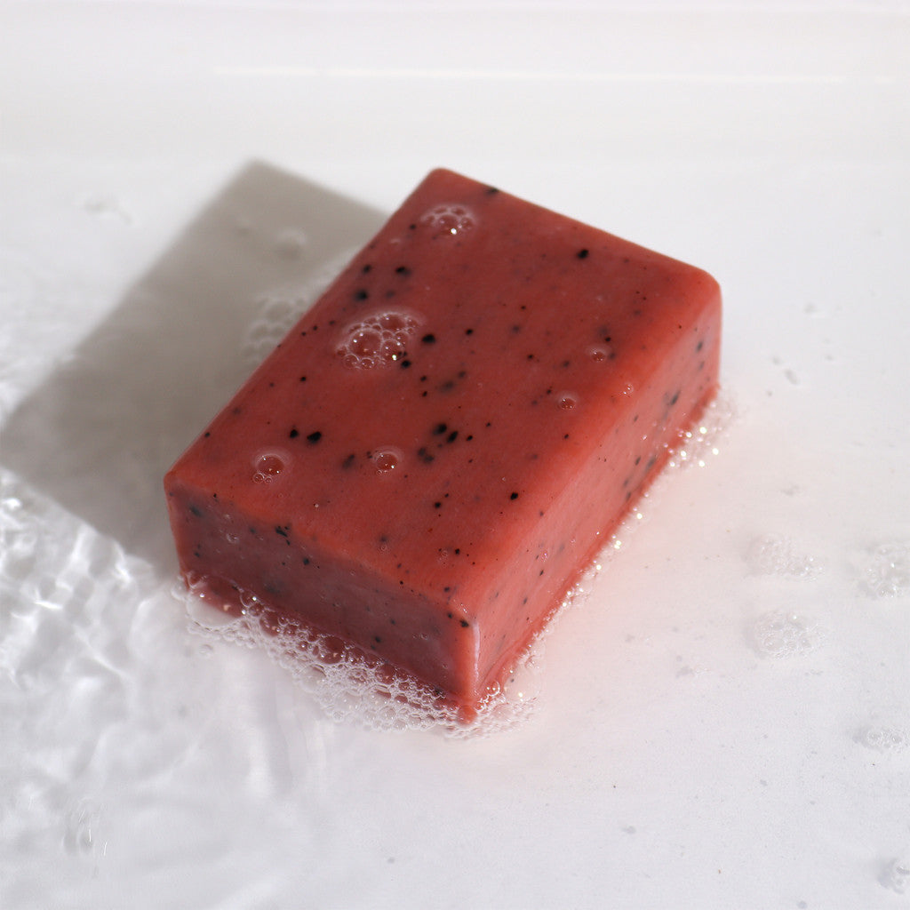 Close-up of Orange & Ginger clay soap with lather; exfoliating speckles visible
