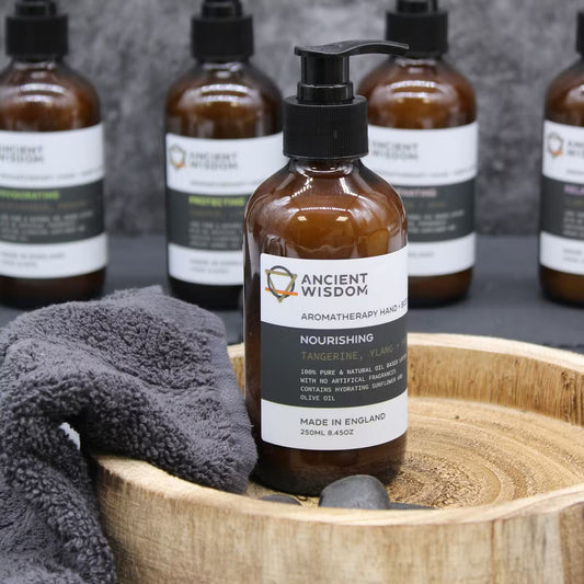 Lumaysa Rejuvenating Hand & Body Lotion – Sandalwood & Rose displayed in a spa-style setting with towels, natural aromatherapy body care made in England