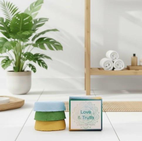 Lumaysa Love & Truth chakra bath fizzers displayed in a calm spa-inspired bathroom setting with plants and natural light, wellness self-care ritual.