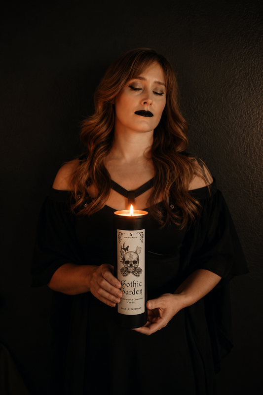 Woman holding a candle labeled 'Gothic Garden' against a dark background