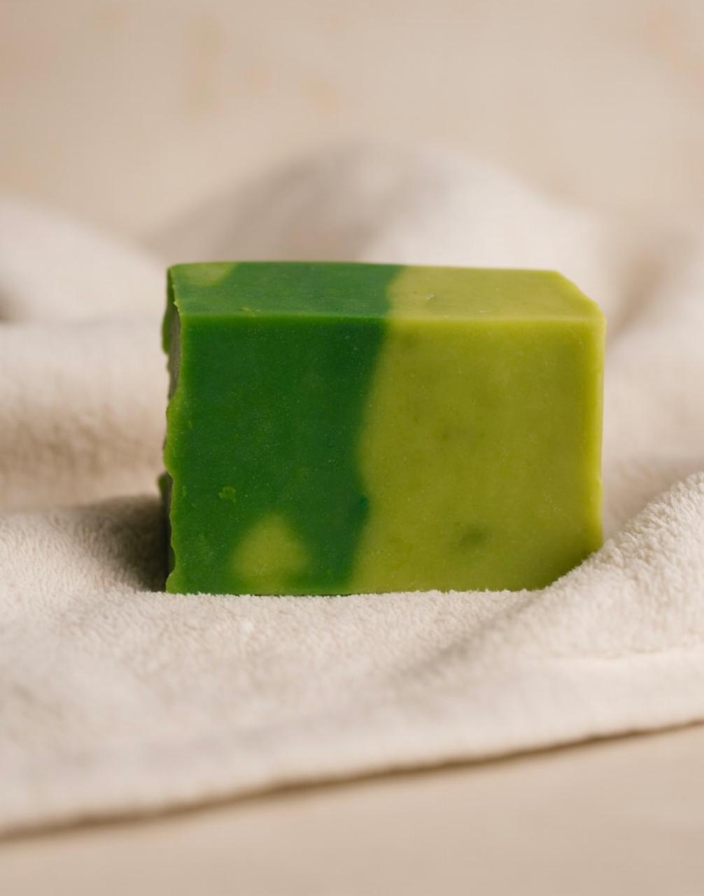 Lumaysa green marbled bar soap resting on a folded cream towel in soft studio light — lifestyle close-up.