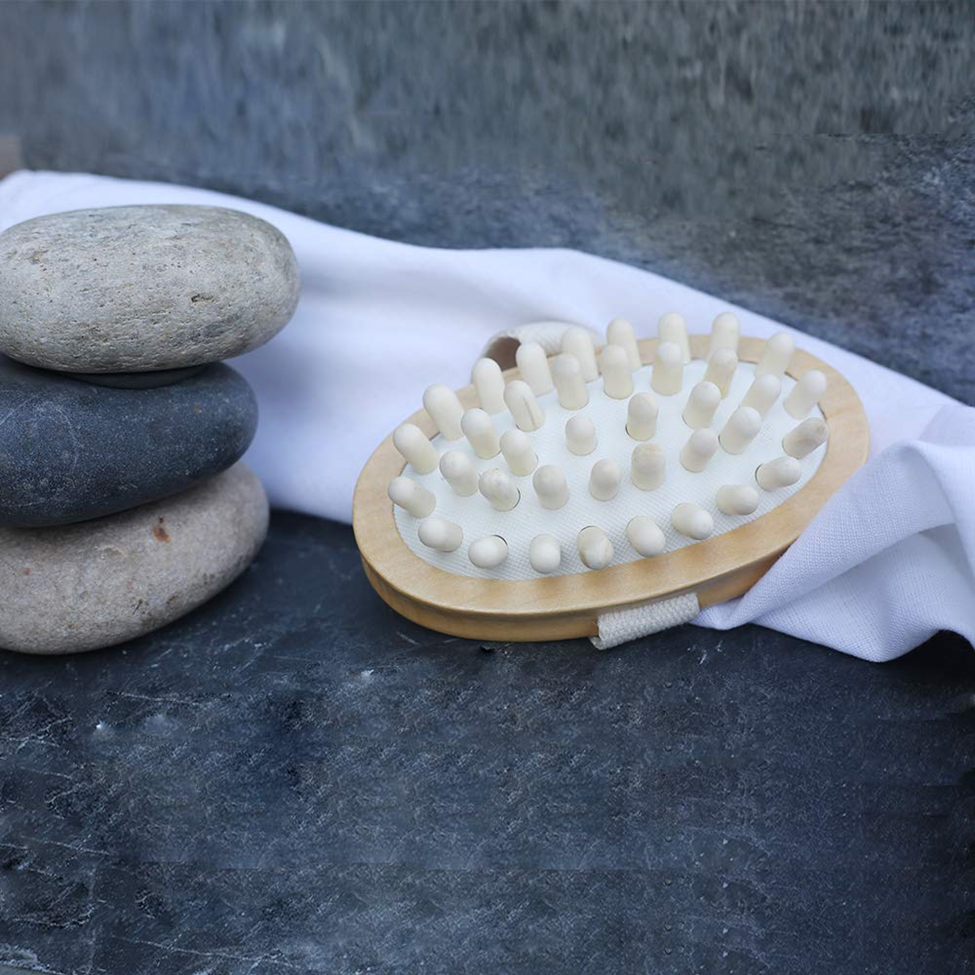 Lumaysa wooden massage brush in a spa setting with stones, wood therapy body massager for a relaxing self-care ritual