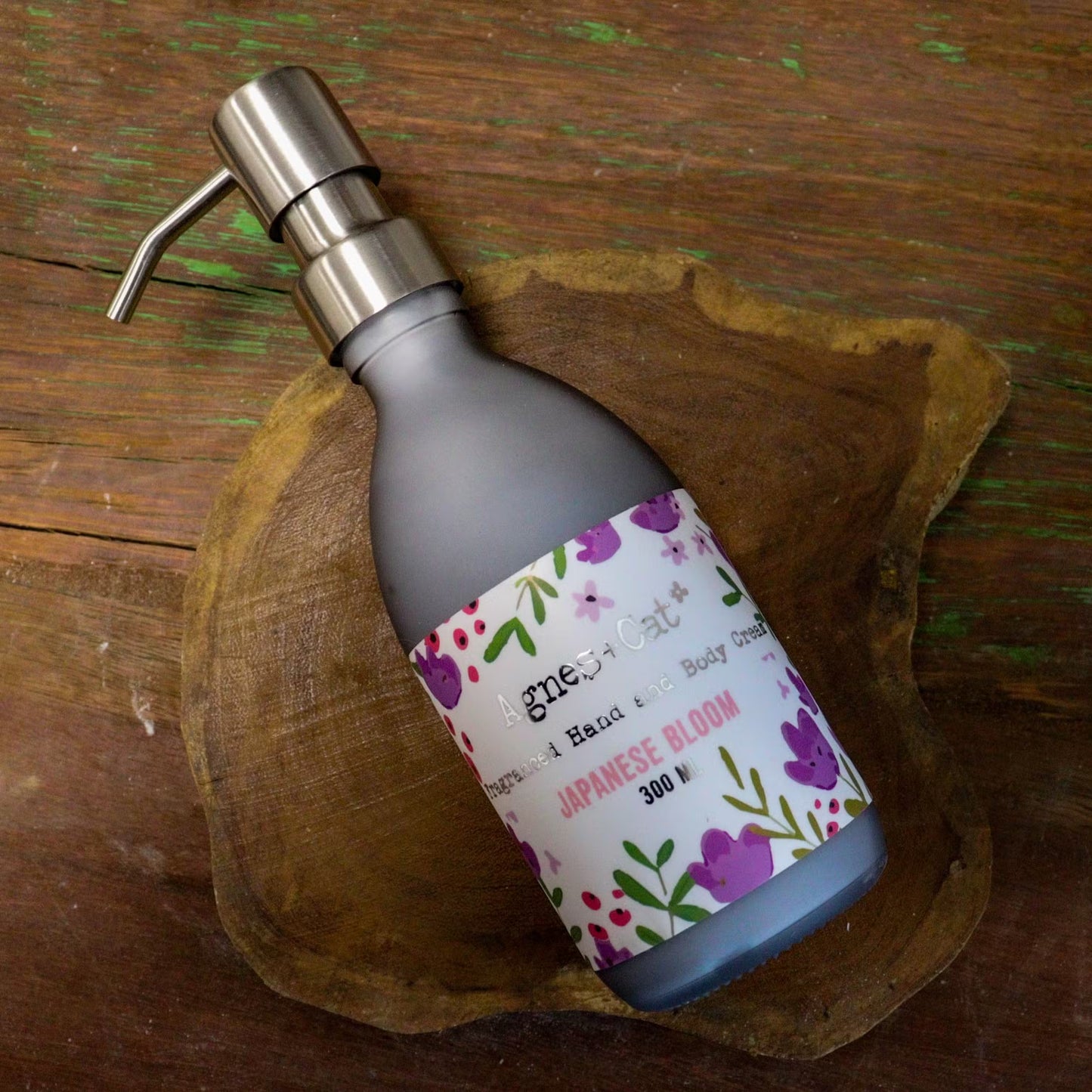 Lumaysa Sakura Whisper Hand & Body Lotion 300ml displayed on a rustic wooden surface, highlighting natural self-care and artisanal beauty
