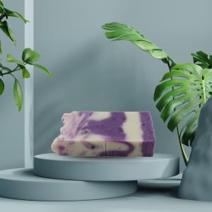 Lavender & olive oil soap bar on a ceramic tray with green plant, calming bathroom setup