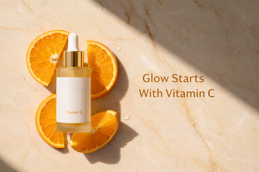Vitamin C serum with orange slices on marble background with text “Glow Starts With Vitamin C” for radiant glowing skin