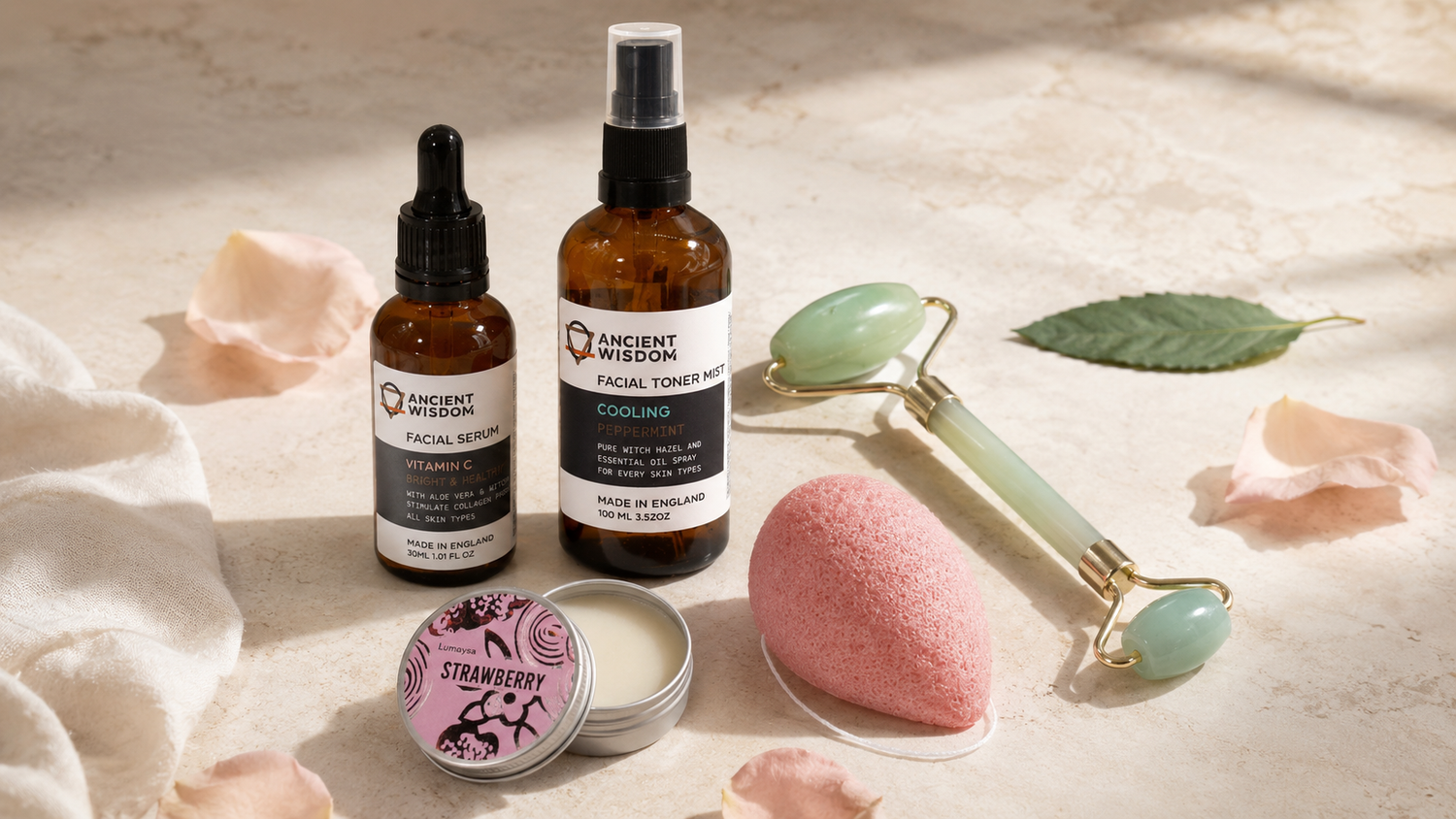 Natural face care collection with facial serum, toner mist, konjac sponge, lip balm and gemstone facial roller.