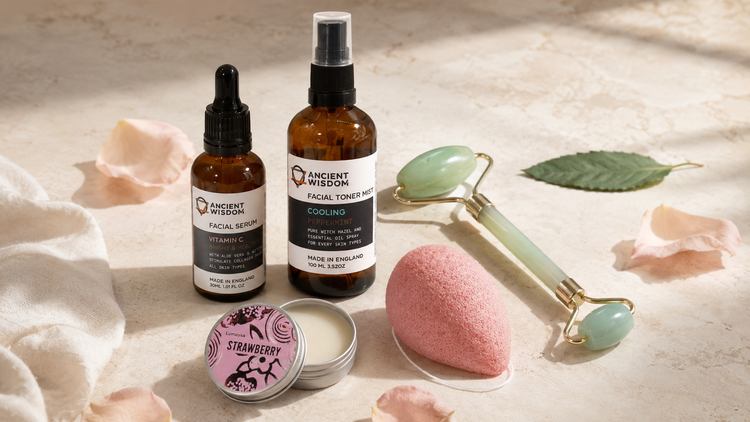 Natural face care collection with facial serum, toner mist, konjac sponge, lip balm and gemstone facial roller.