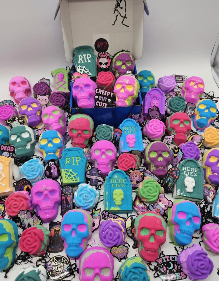 Halloween bath bombs collection featuring colorful skull-shaped and tombstone bath bombs in vibrant neon colors, perfect for spooky self-care gifts