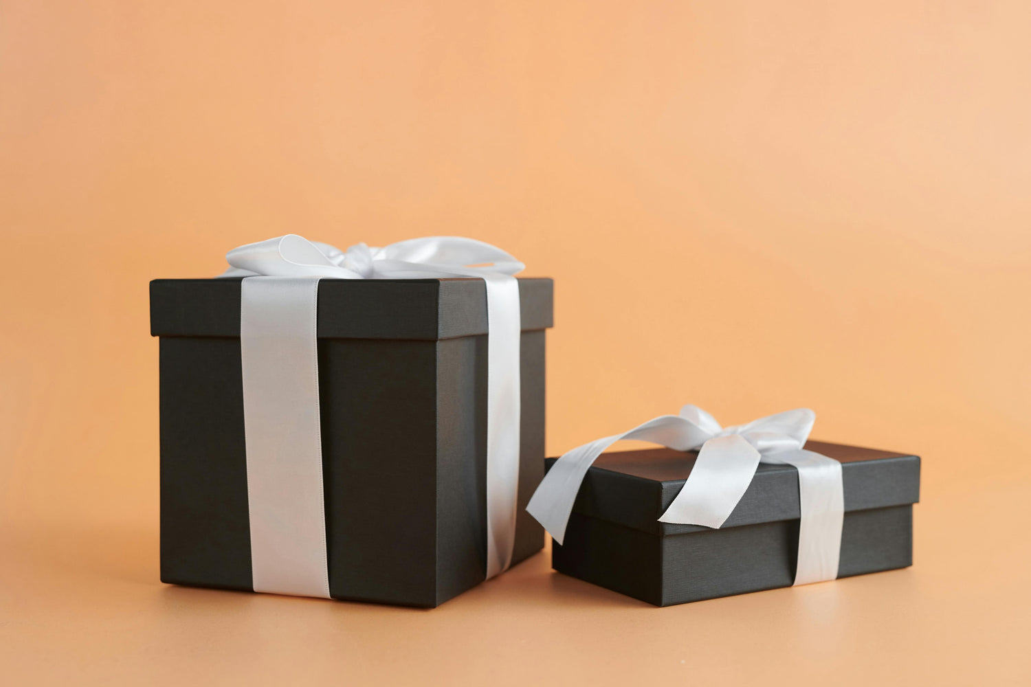 Luxury black gift boxes with white ribbon – elegant self-care gift set packaging by Lumaysa