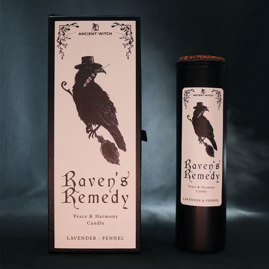 “Raven’s Remedy ritual candle with gift box – matte black tube and illustrated raven design on a dark moody background.”