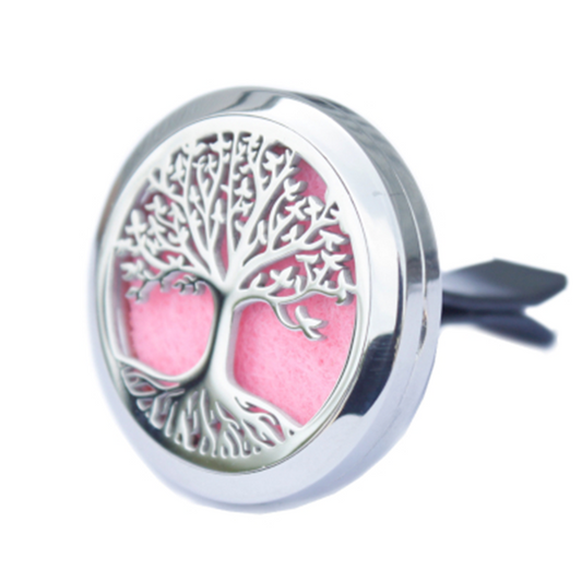 Decorative diffuser with tree of life design on a pink background
