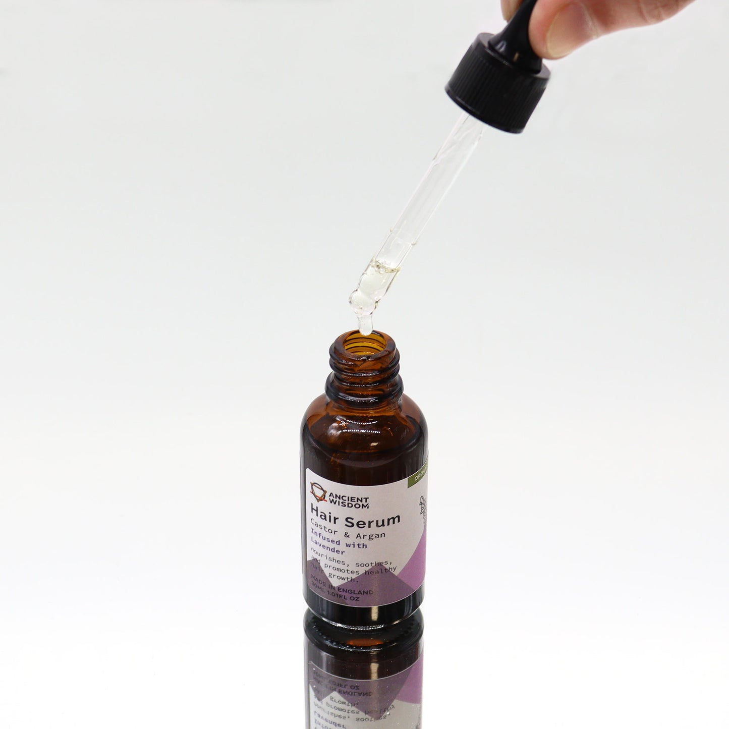 Applying Lumaysa Serenity Elixir lavender hair oil using dropper, soothing scalp serum with botanical oils