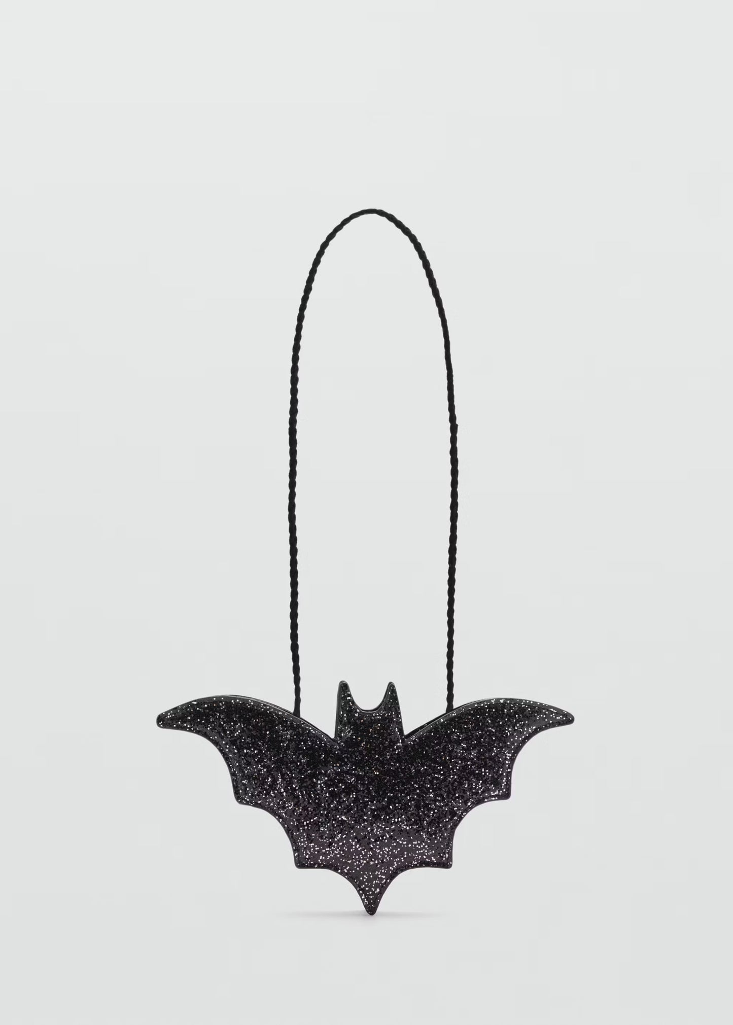 Black bat-shaped bath bomb with glitter texture on a clean white background, Lumaysa Midnight Wings luxury Halloween bath bomb