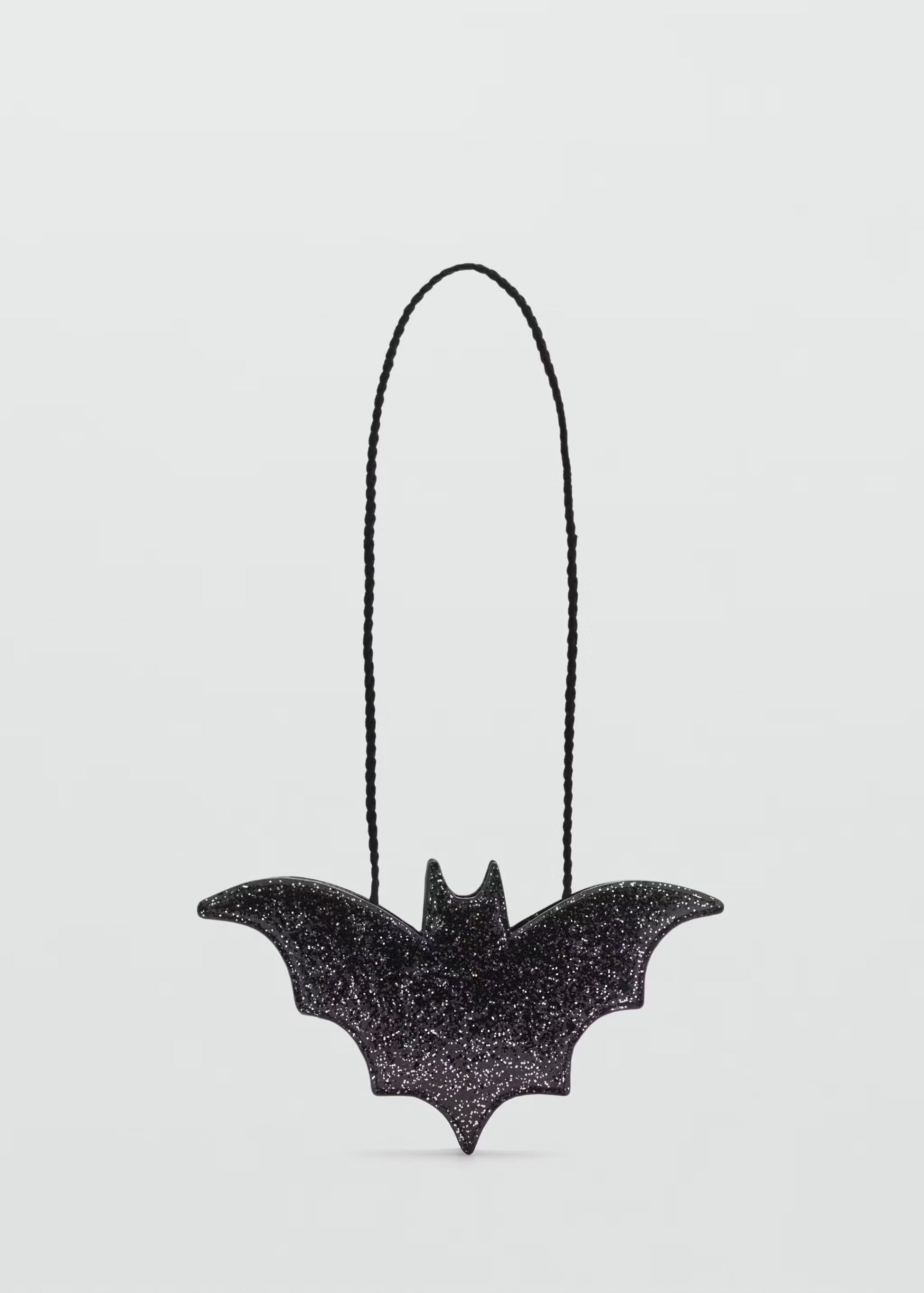 Black bat-shaped bath bomb with glitter texture on a clean white background, Lumaysa Midnight Wings luxury Halloween bath bomb