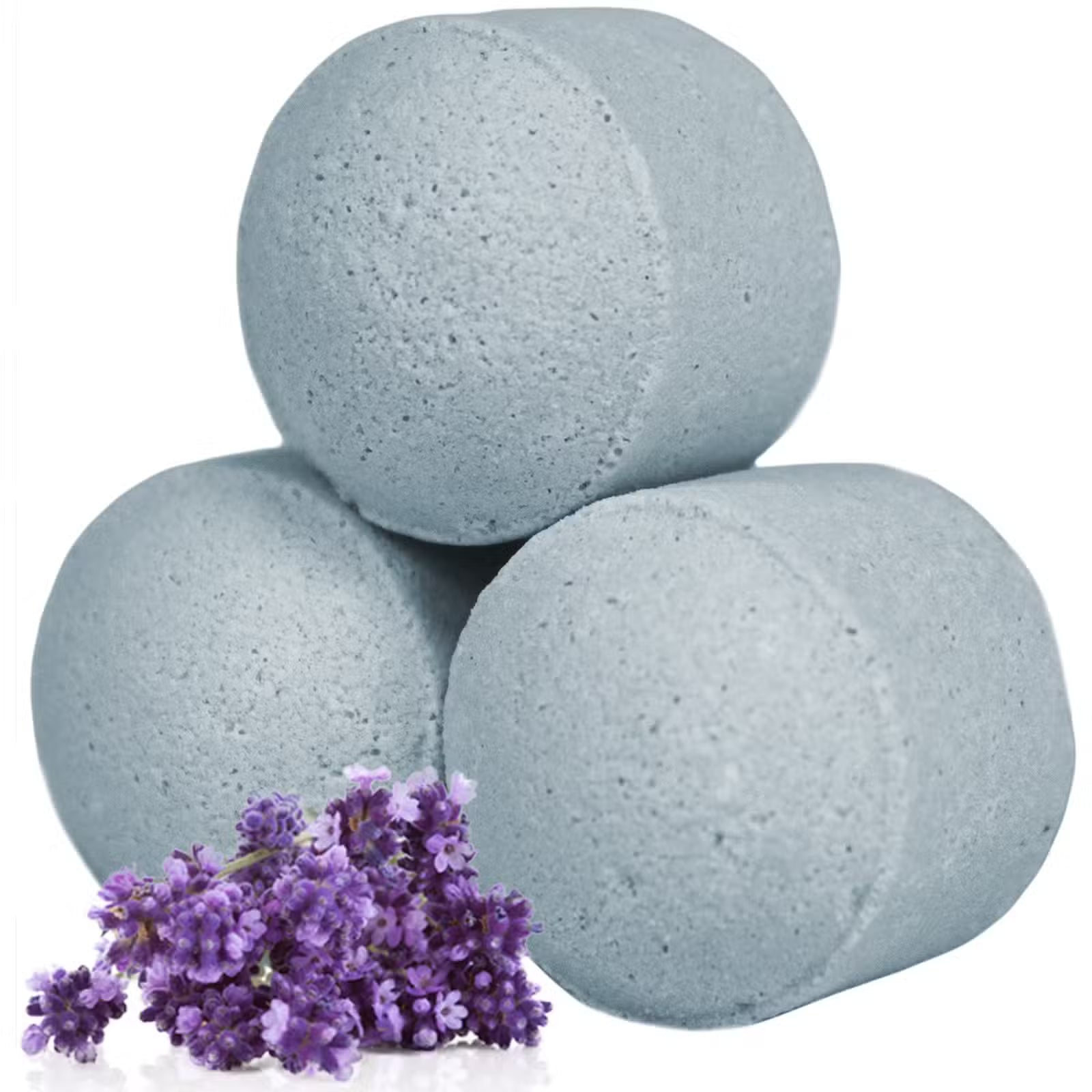 Three grey lavender bath bomb chill pills stacked with fresh purple lavender flowers on a clean white background, Lumaysa Serenity Soak.