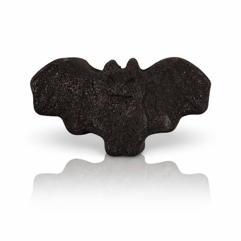 Black bat-shaped bath bomb with shimmer texture on white background with reflection, luxury Halloween bath product by Lumaysa