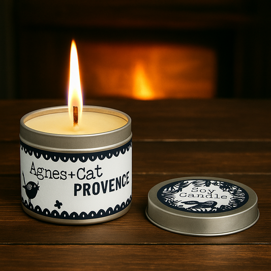 Lit Lumaysa Provence soy candle in reusable tin on wooden surface with warm ambient glow