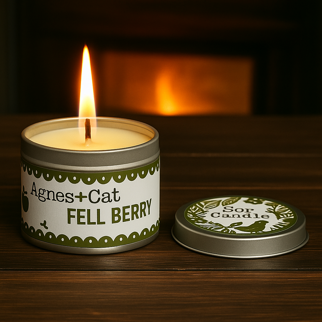 Lumaysa Fell Berry fruity soy candle lit in reusable tin with warm ambient light and green berry label