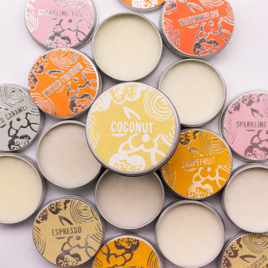 Assorted vegan lip balms by Agnes & Cat with Lumaysa Tropical Bliss Coconut lip balm tin featured at the centre, showcasing natural solid balm texture.