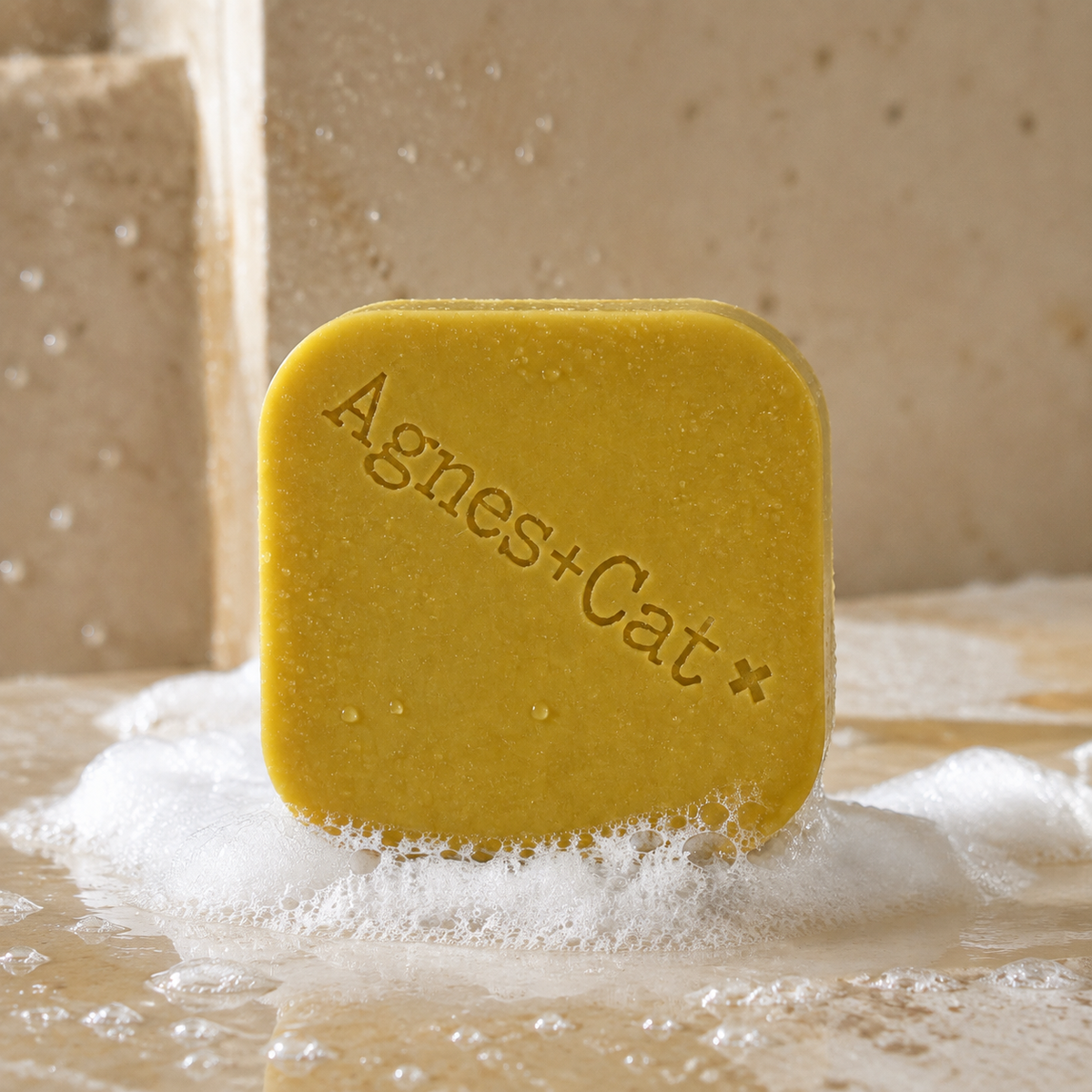 Moroccan Roll solid shampoo bar with natural foam and water droplets in a stone shower