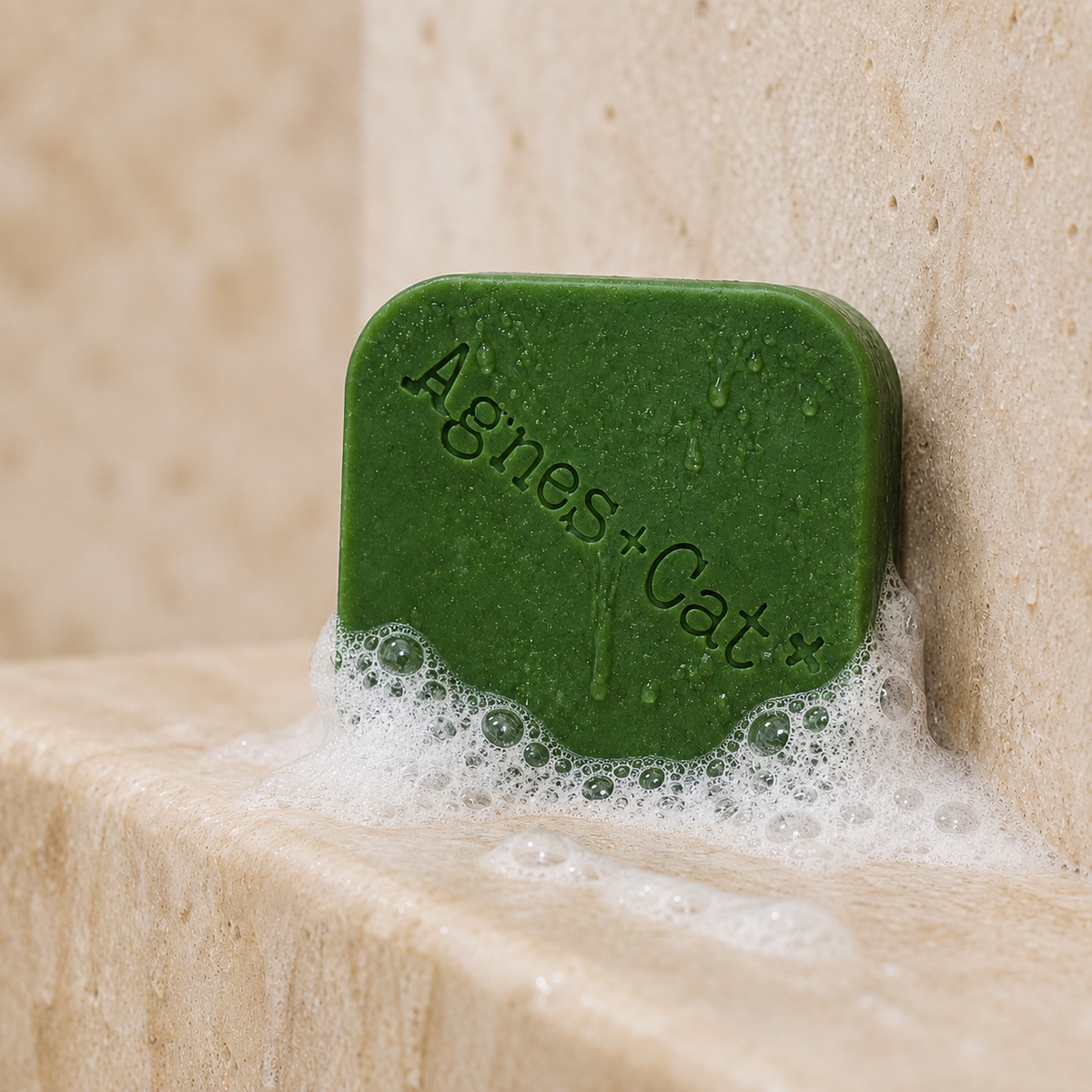 Rhubarb solid shampoo bar with natural foam and water droplets in a stone shower