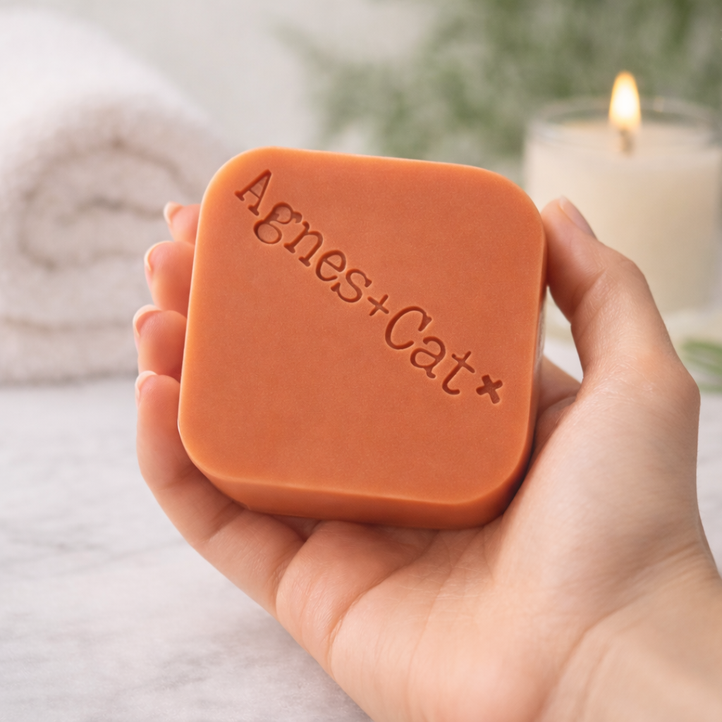 Hand holding Agnes + Cat Clementine solid shampoo bar, vegan citrus shampoo bar for shiny hair by Lumaysa