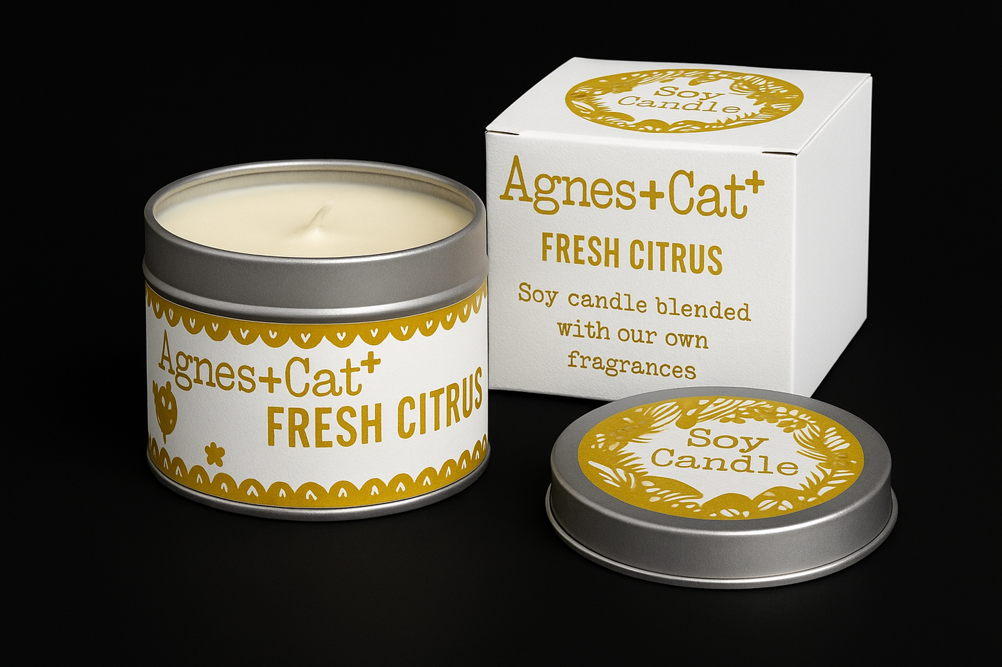 Lumaysa Citrus Glow soy candle in reusable tin with matching gift box on black background
