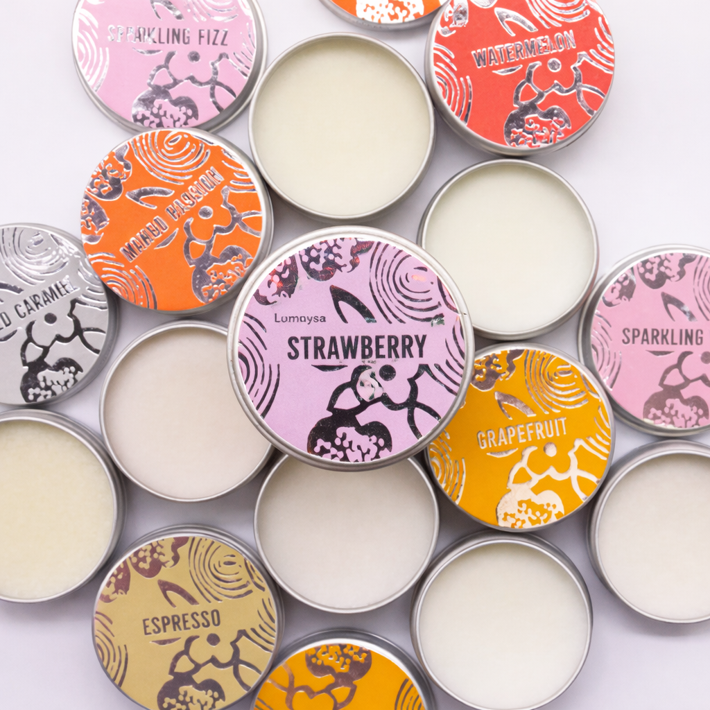 Assorted vegan lip balms by Agnes & Cat displayed open, featuring Lumaysa Strawberry Bliss lip balm with natural nourishing formula.