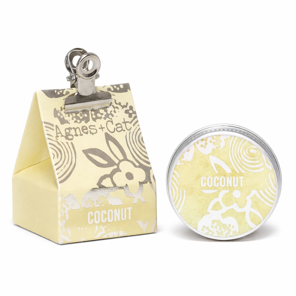 Lumaysa Tropical Bliss Coconut vegan lip balm by Agnes & Cat, featuring the metal tin beside its eco-friendly cardboard packaging.