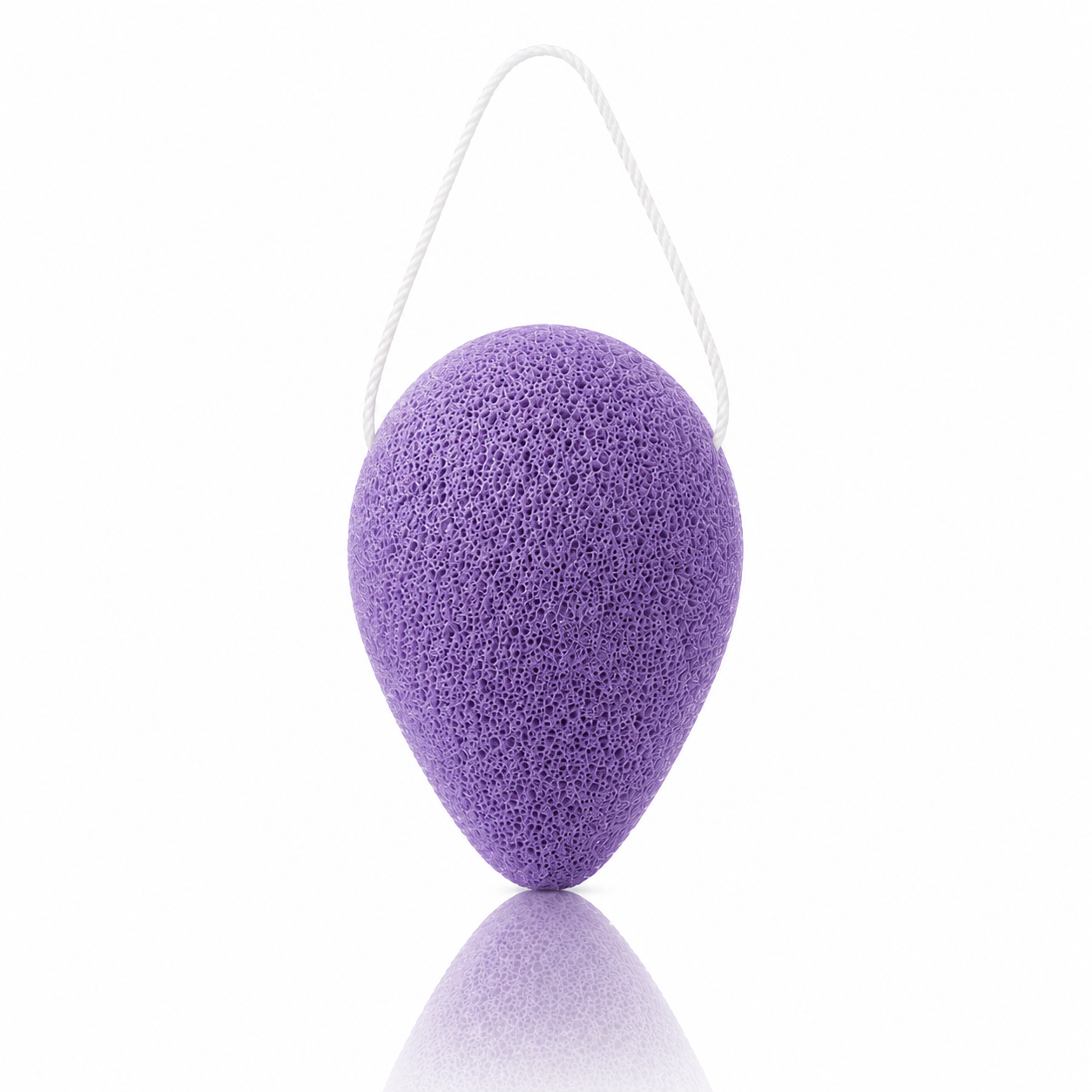 Lavender konjac facial sponge with a white hanging string on a clean white background.