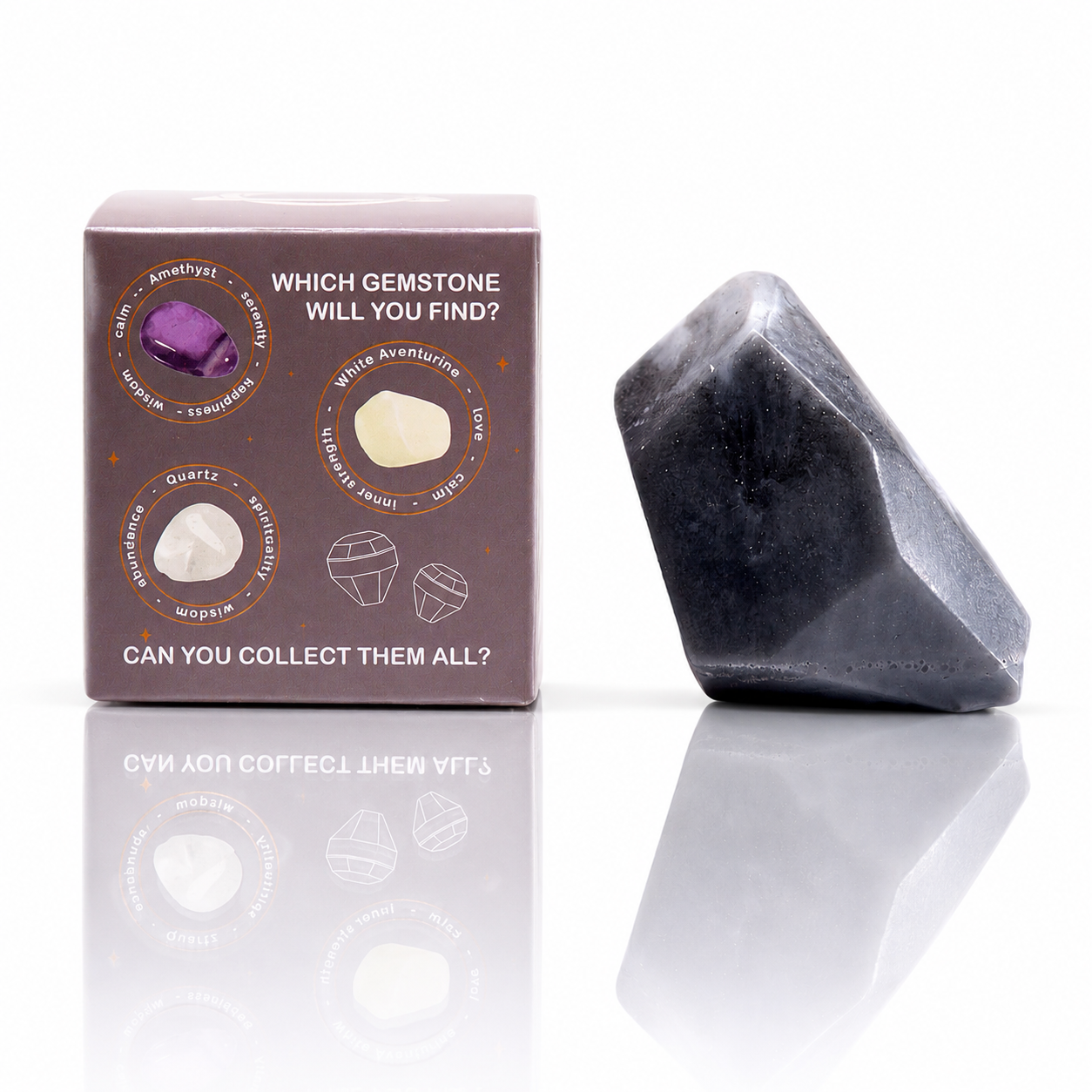 Box of gemstone hunt game with a dark stone on a white background
