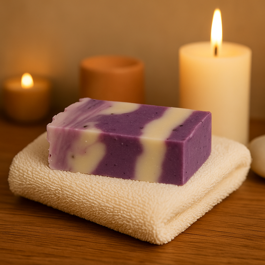 Handmade lavender & olive oil soap bar on a cream towel with candles, warm spa scene