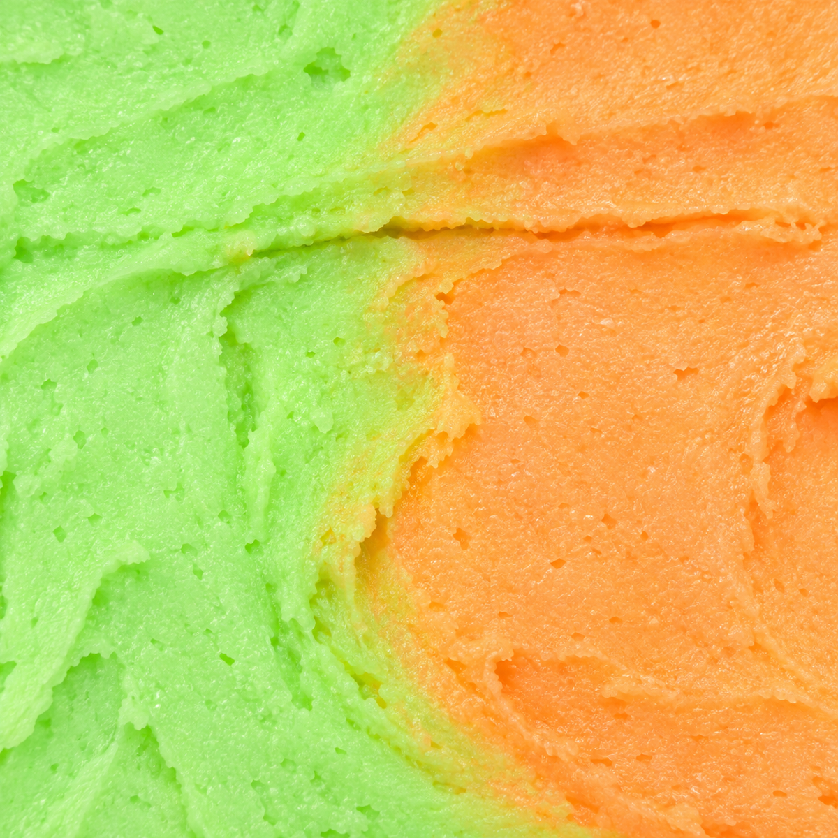 Close-up of the creamy two-tone green and orange texture of Mango & Lime Whipped Soap.