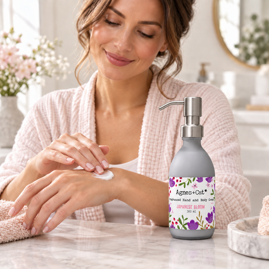 Woman applying Agnes + Cat Japanese Bloom Hand and Body Cream with the bottle pump facing towards her hands