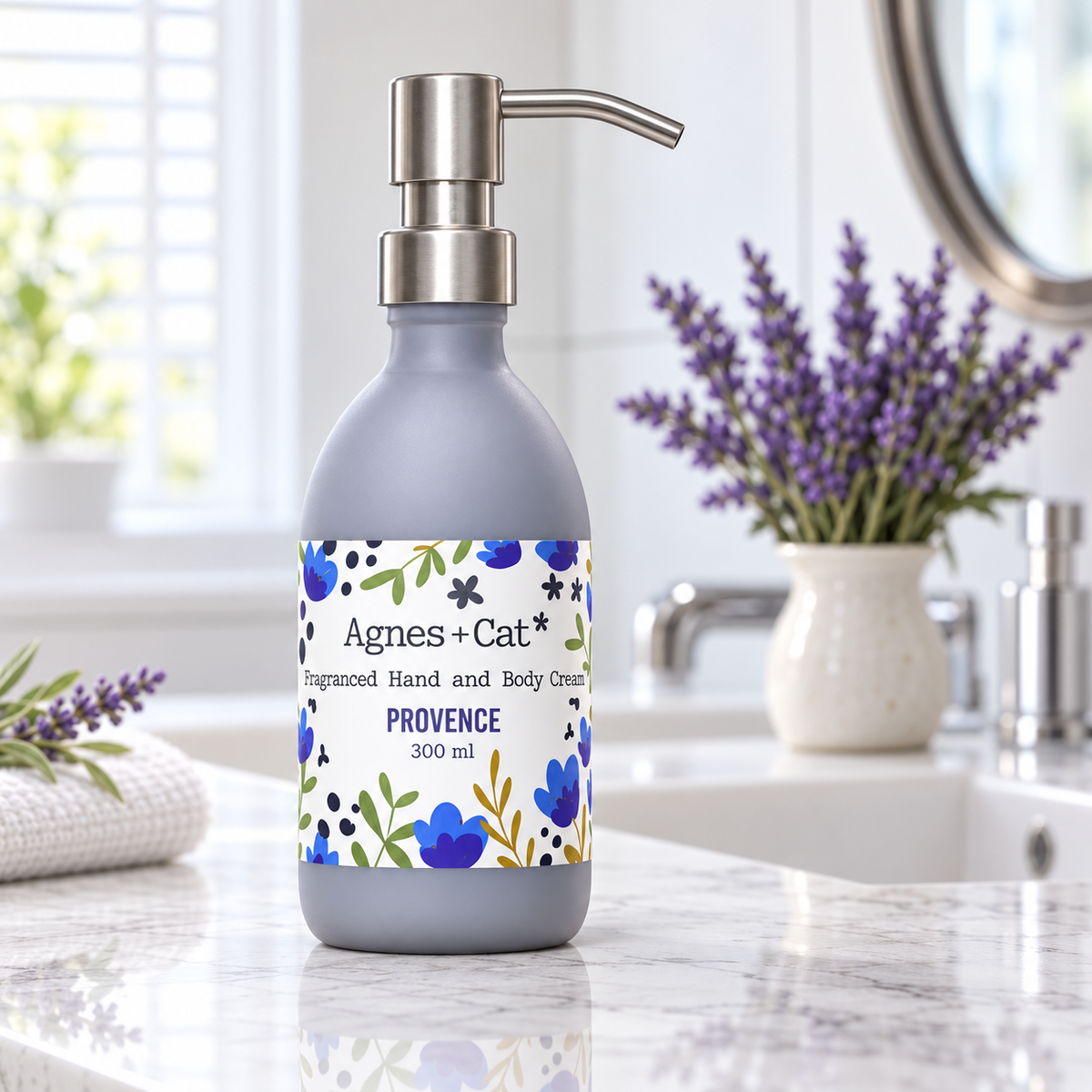 Agnes + Cat Provence Hand and Body Cream 300ml displayed on a marble bathroom counter with lavender flowers
