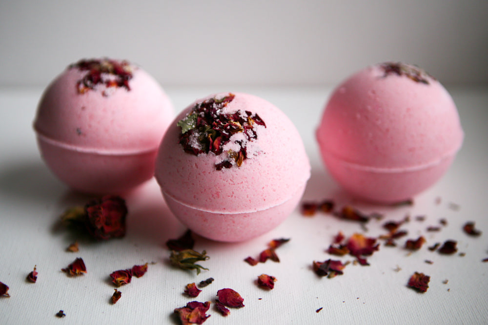 Close-up of Lumaysa rose bath bombs with dried rose petals, luxury floral bath bomb aesthetic for romantic spa and relaxation ritual