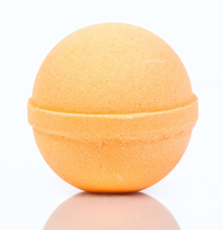 Orange bath bomb on a white background