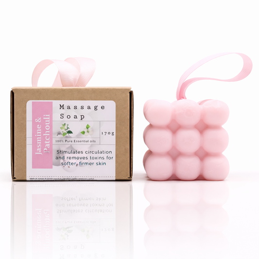 Luxury jasmine and patchouli massage soap set with pink bubble soap and packaging, clean white background with reflection, premium European skincare style