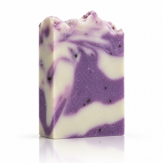 Purple and cream marbled handmade soap bar standing upright on a white background, with a soft reflection beneath.