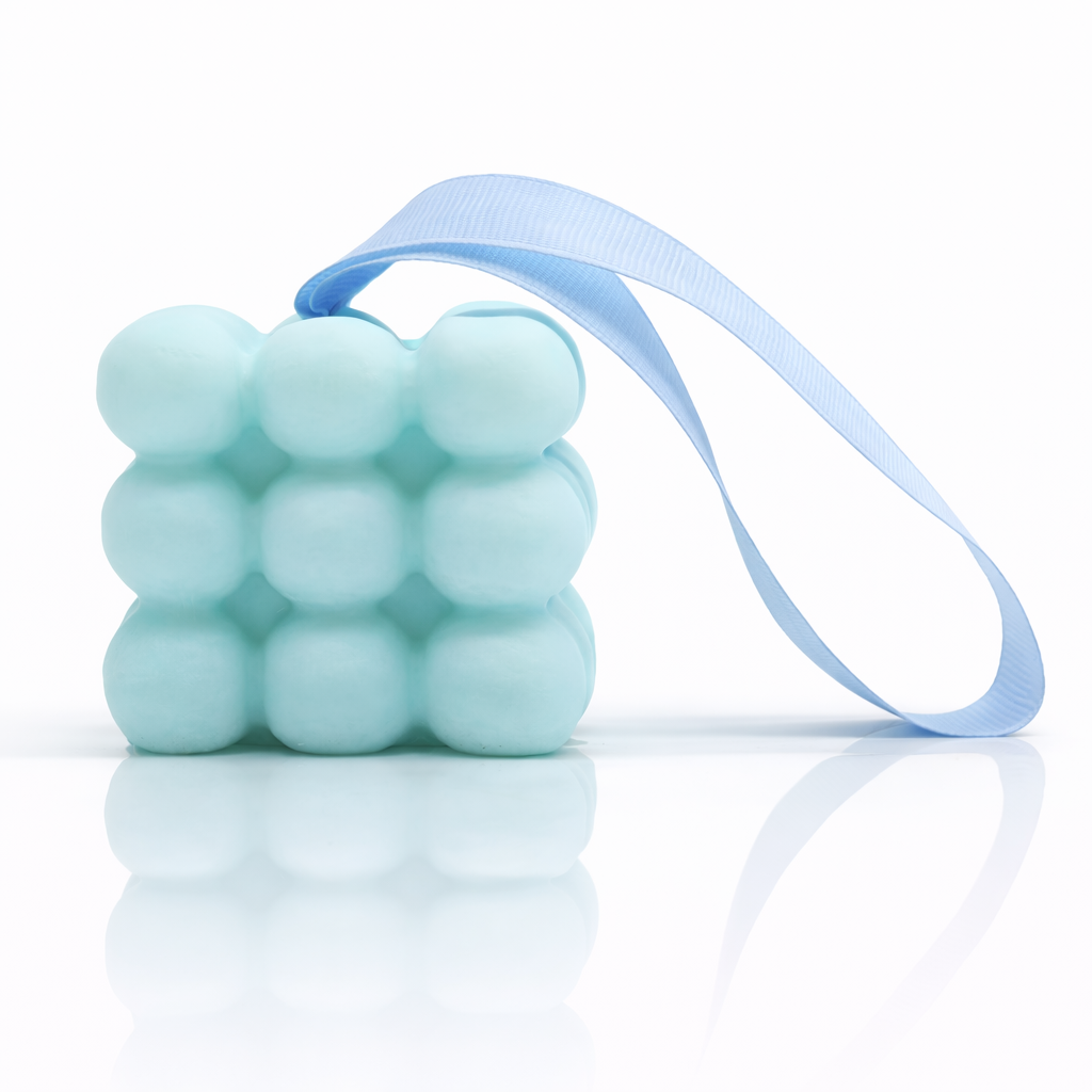 Blue bubble massage soap with ribbon on white background with strong reflection and premium clean skincare style