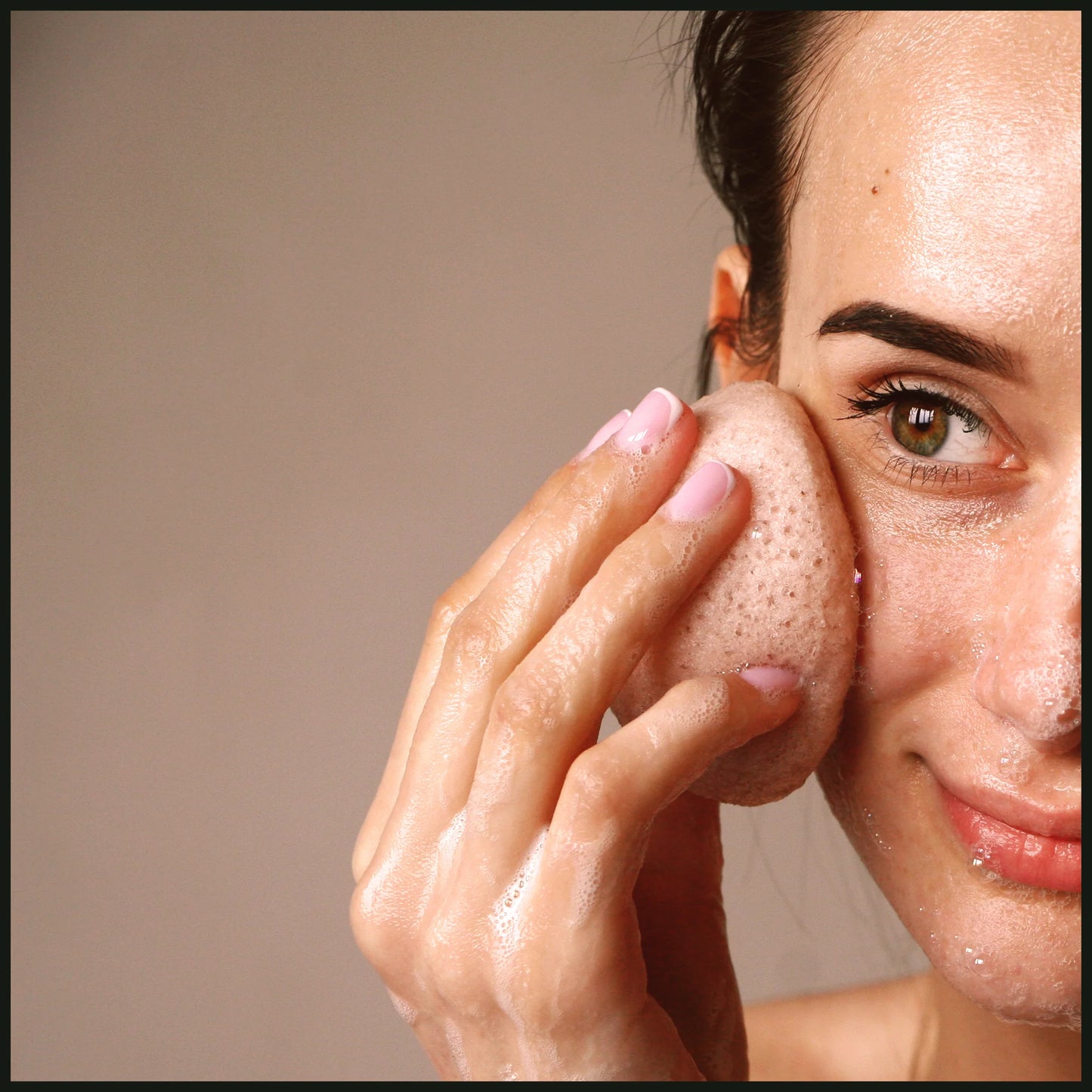 Woman gently cleansing her face with Lumaysa rose konjac sponge for daily facial care