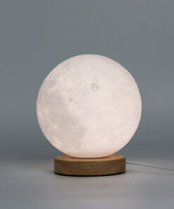 Lumaysa Moon Glow sculpted ambient table lamp with warm LED light and natural wooden base on a minimalist grey background.