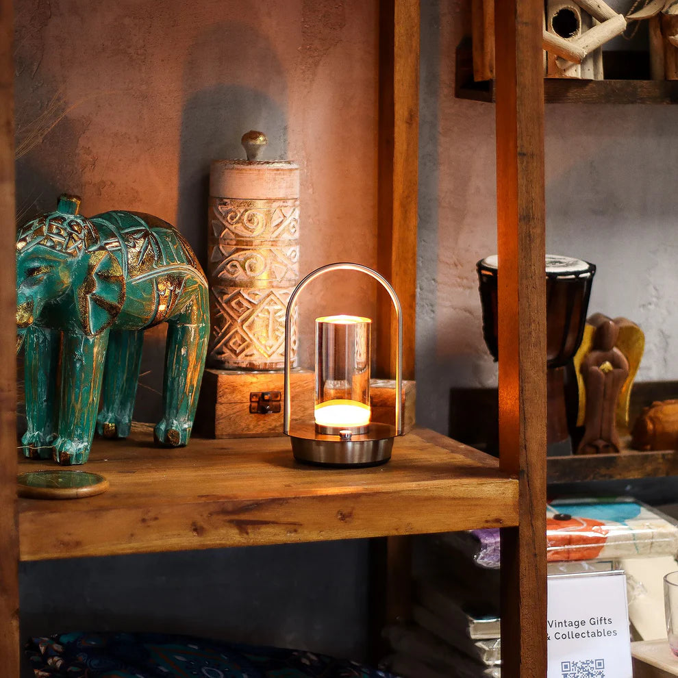 Lumaysa Crystal Lantern ambient table lamp styled in a cozy interior setting, casting a warm glow among decorative objects.