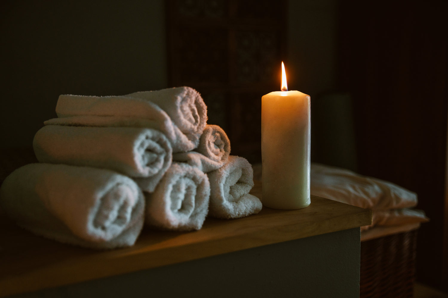 Luxury spa candle with soft towels, warm evening ritual
