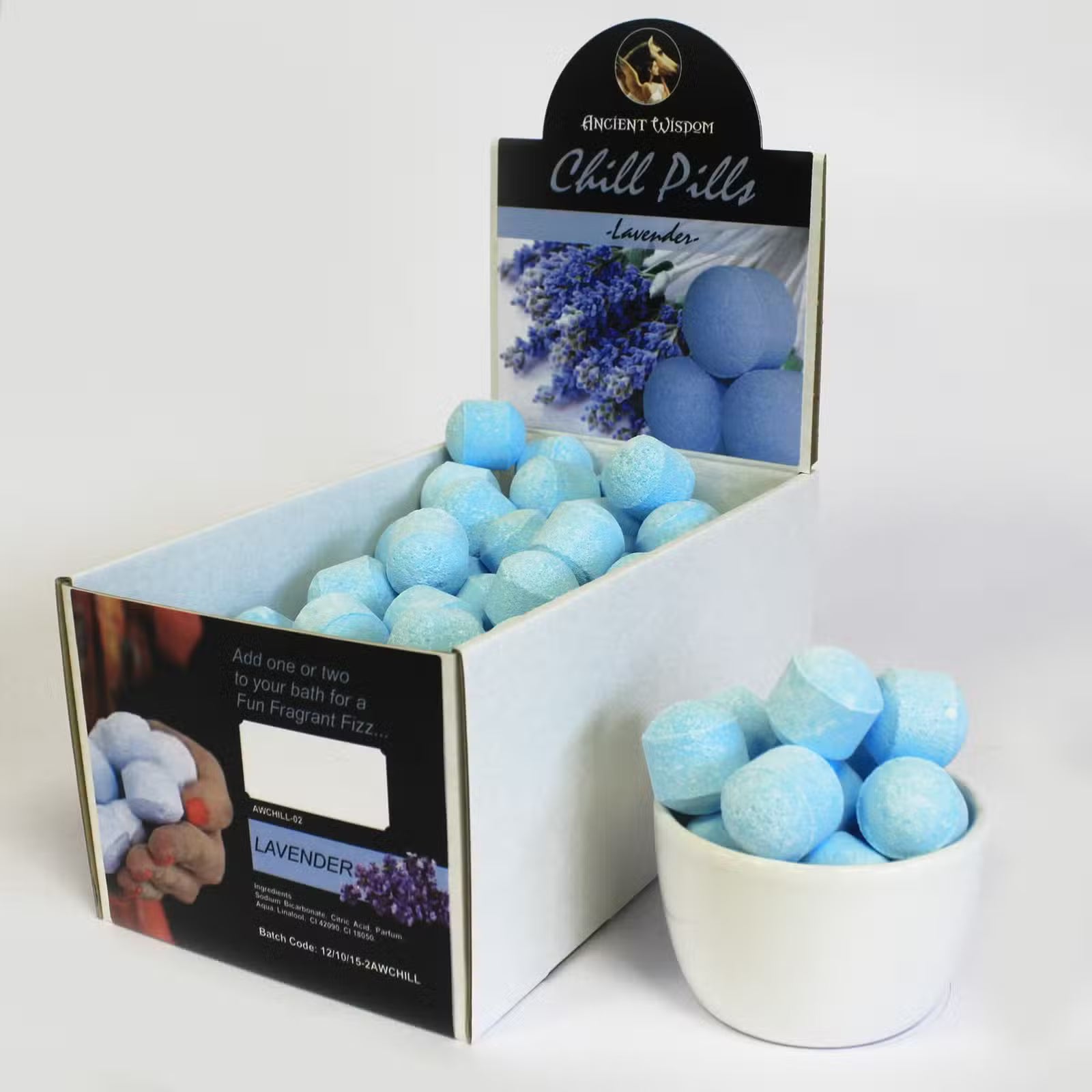 Open display box of Lumaysa lavender bath bomb chill pills showing multiple mini fizzers arranged for retail presentation.