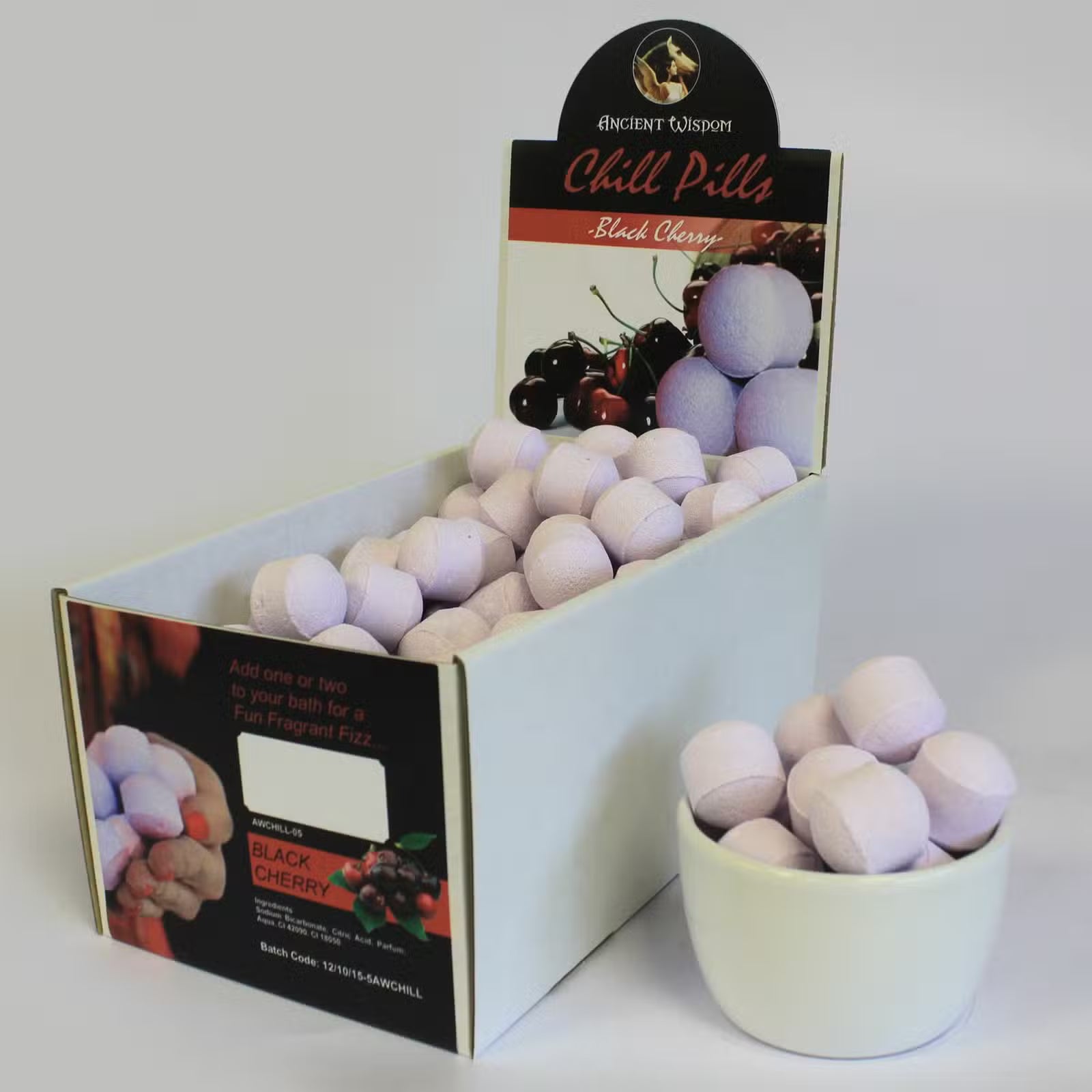 Open display box of Lumaysa black cherry bath bomb chill pills showing multiple mini fizzers arranged for retail presentation.