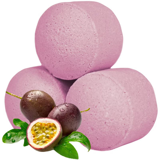 Pink passion fruit bath bomb chill pills stacked with fresh passion fruit and green leaves on a clean white background, Lumaysa Tropical Oasis.