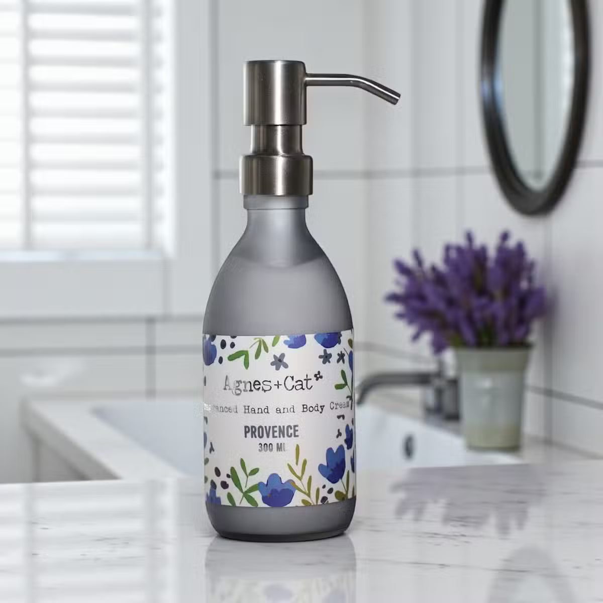 Lumaysa Lavender Provence Hand & Body Lotion (300ml) in a matte grey pump bottle, styled in a modern bathroom with soft lavender accents for a calming self-care aesthetic.