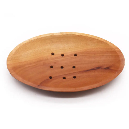 Wooden soap dish with holes on a white background