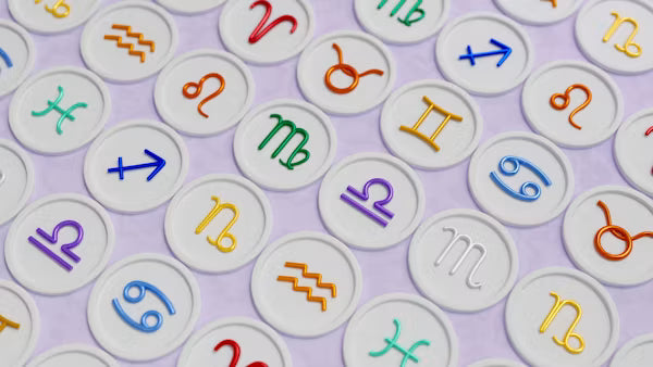 Astrology-themed image featuring colorful zodiac signs on white circular tokens, perfect for horoscope and zodiac content.